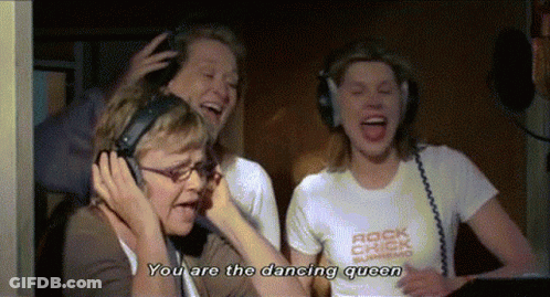 A Woman Wearing Headphones Says " You Are The Dancing Queen " While Another Woman Laughs GIF