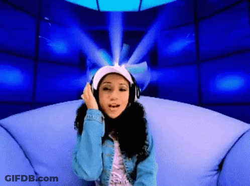 A Woman Wearing Headphones Sitting On A Couch GIF