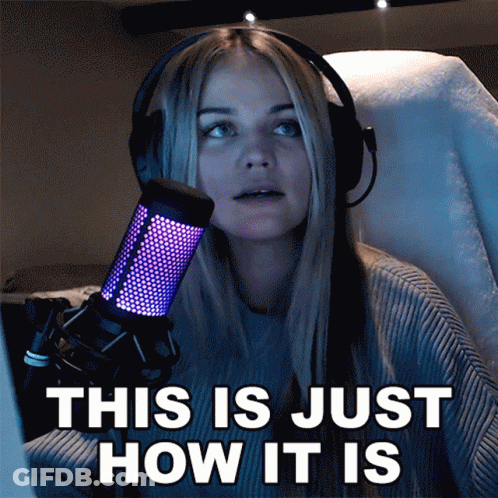 A Woman Wearing Headphones Stands In Front Of A Microphone And Says This Is Just How It Is GIF