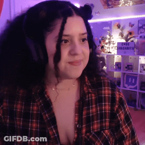 A Woman Wearing Headphones Stands In Front Of A Sign That Says " I Love Shagarita " GIF