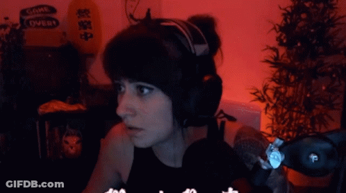 A Woman Wearing Headphones With A Sign That Says Come Over In The Background GIF