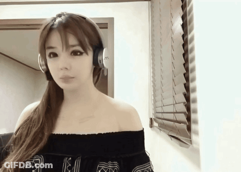 A Woman Wearing Headphones With The Letter I On The Bottom GIF
