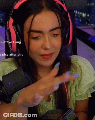 A Woman Wearing Headphones With The Name Gustavo Fring Visible GIF