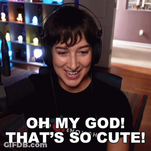 A Woman Wearing Headphones With The Words Oh My God That 'S So Cute GIF