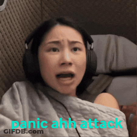 A Woman Wearing Headphones With The Words Panic Ahh Attack Written Below Her GIF