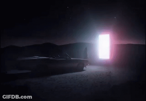 A Woman Wearing High Heels Is Walking On A Sidewalk In A Foggy Room . GIF