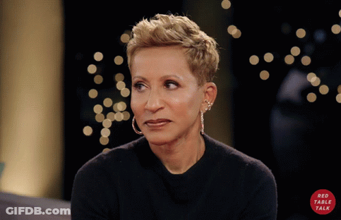 A Woman Wearing Hoop Earrings And A Black Shirt With A Red Circle That Says Red Table Talk GIF