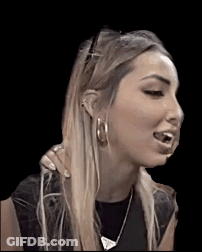 A Woman Wearing Hoop Earrings And A Necklace Is Making A Face GIF