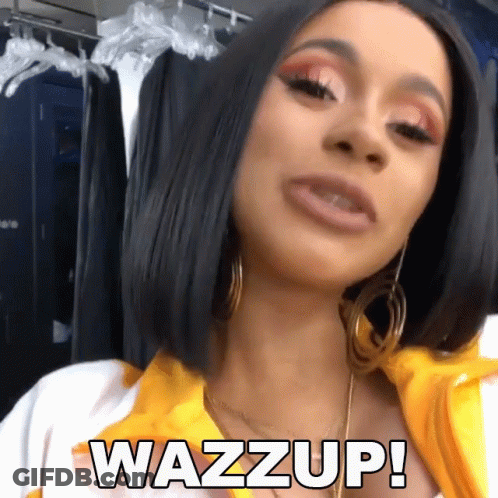 A Woman Wearing Hoop Earrings And A Yellow Shirt Says Wazz Up GIF
