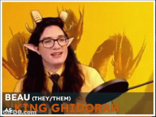 A Woman Wearing Horns And Glasses Is Holding A Frying Pan And Talking . GIF