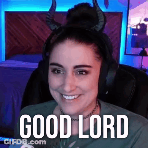 A Woman Wearing Horns And Headphones Is Smiling And Saying Good Lord . GIF