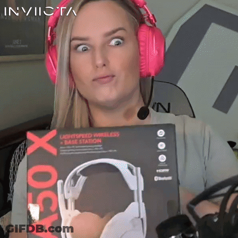 A Woman Wearing Pink Headphones Is Holding A Box That Says A50 X On It GIF
