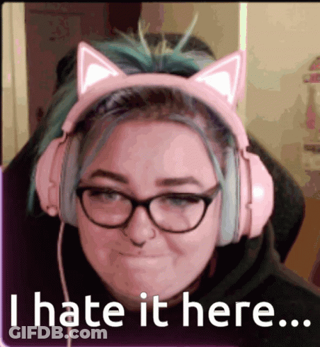 A Woman Wearing Pink Headphones With Cat Ears And Glasses Says I Hate It Here GIF