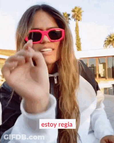 A Woman Wearing Pink Sunglasses And A White Jacket Says Estoy Regia In Spanish . GIF