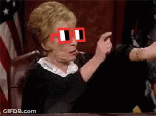 Woman With Red Glasses Sitting At Table GIF