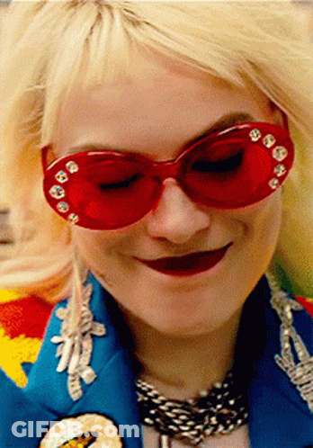 A Woman Wearing Red Sunglasses And A Blue Jacket GIF