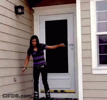 A Woman Wearing Roller Skates Stands In Front Of A White Door GIF