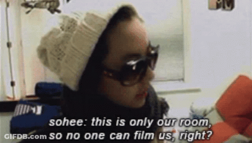 A Woman Wearing Sunglasses And A Beanie Says Sohee This Is Only Our Room So No One Can Film Us Right ? GIF
