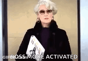 A Woman Wearing Sunglasses And A Fur Coat Is Holding A Newspaper And A Magazine . GIF