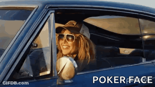 A Woman Wearing Sunglasses And A Hat Is Sitting In A Car With Poker Face Written On The Bottom GIF