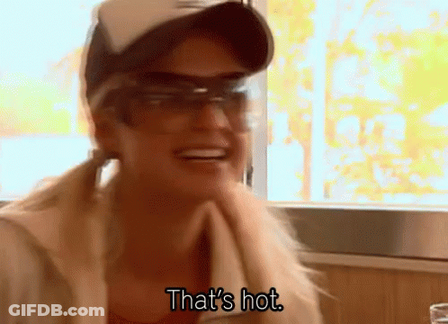 A Woman Wearing Sunglasses And A Hat Is Smiling And Saying That 'S Hot GIF