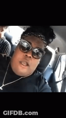 A Woman Wearing Sunglasses And A Headband Is In A Car . GIF