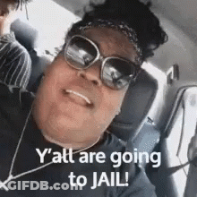 A Woman Wearing Sunglasses And A Headband Is Sitting In A Car And Smiling . GIF