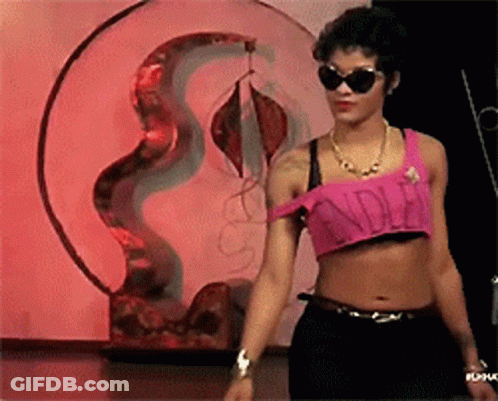 A Woman Wearing Sunglasses And A Pink Crop Top That Says ' Cinderella ' On It GIF