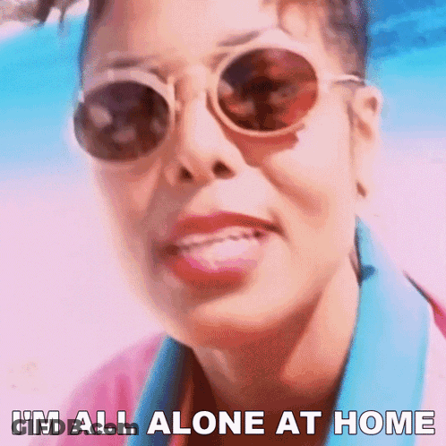 A Woman Wearing Sunglasses And A Pink Shirt Says I 'M All Alone At Home GIF