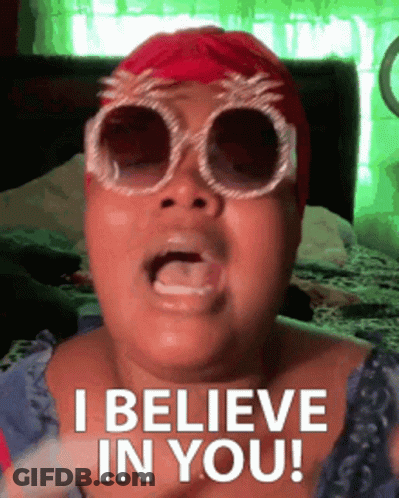 A Woman Wearing Sunglasses And A Red Hat Is Saying I Believe In You GIF
