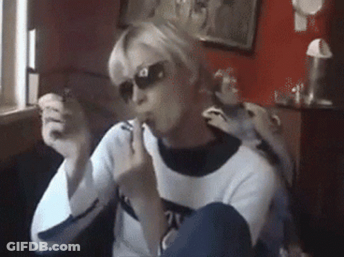 A Woman Wearing Sunglasses And A Sweater With The Number 21 On The Front GIF