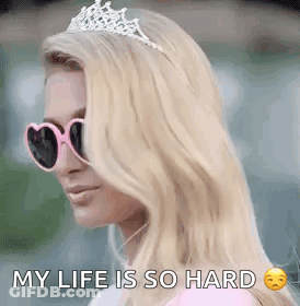A Woman Wearing Sunglasses And A Tiara Is Saying `` My Life Is So Hard `` . GIF