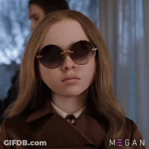 A Woman Wearing Sunglasses And A Trench Coat With Megan Written On The Bottom Right GIF