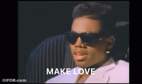A Woman Wearing Sunglasses And A White Jacket With The Words Make Love Above Her GIF