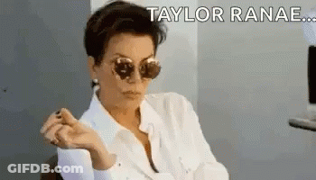 A Woman Wearing Sunglasses And A White Shirt Is Sitting In A Chair And Making A Funny Face . GIF