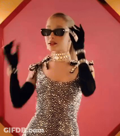 A Woman Wearing Sunglasses And Gloves Is Talking On A Cell Phone GIF
