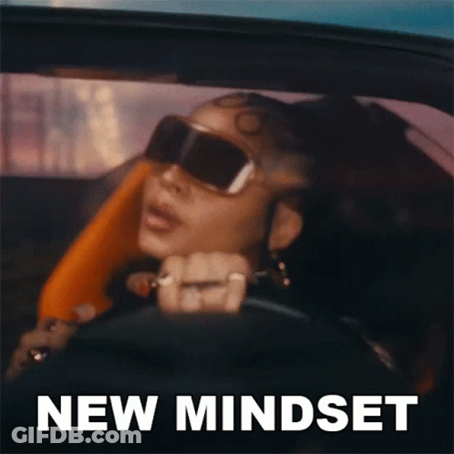 A Woman Wearing Sunglasses Is Driving A Car With The Words New Mindset Written On The Bottom GIF
