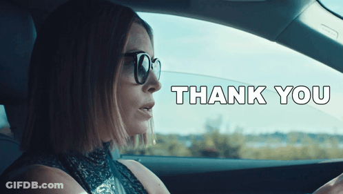 A Woman Wearing Sunglasses Is Driving A Car With The Words Thank You Written On The Bottom GIF