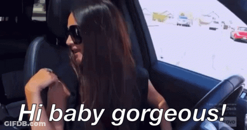 A Woman Wearing Sunglasses Is Sitting In A Car With The Words Hi Baby Gorgeous Below Her GIF