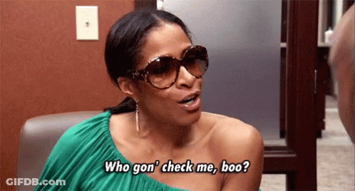A Woman Wearing Sunglasses Is Sitting In A Chair And Talking To Someone . GIF