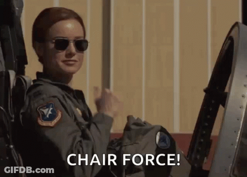 A Woman Wearing Sunglasses Is Sitting In A Chair With The Words Chair Force Below Her GIF