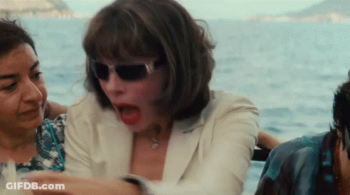 A Woman Wearing Sunglasses Is Sitting On A Boat With Other People GIF