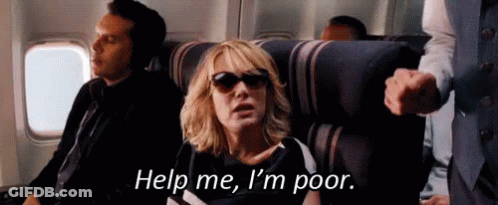A Woman Wearing Sunglasses Is Sitting On A Plane . GIF