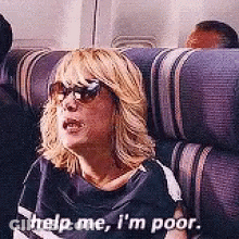 A Woman Wearing Sunglasses Is Sitting On A Plane And Says Help Me I 'M Poor . GIF