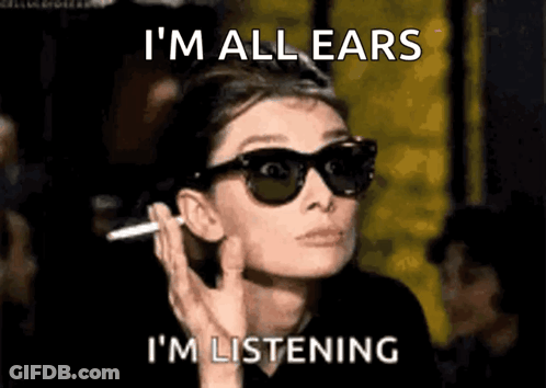A Woman Wearing Sunglasses Is Smoking A Cigarette And The Caption Says I 'M All Ears I 'M Listening GIF