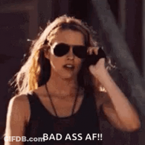 A Woman Wearing Sunglasses Is Talking On A Cell Phone And Says `` Bad Ass Af '' . GIF
