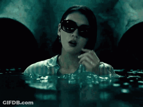 A Woman Wearing Sunglasses Is Talking On A Cell Phone In The Water And The Chance Of Survival Was Increased From 66 To 1 GIF