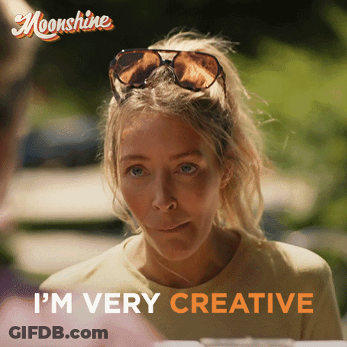 A Woman Wearing Sunglasses Says " I 'M Very Creative " In Orange Letters GIF