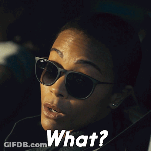 A Woman Wearing Sunglasses Says " What " In White Letters GIF
