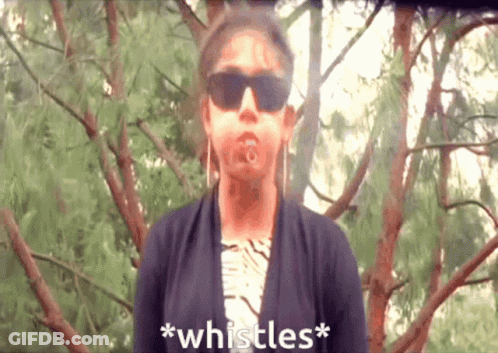 A Woman Wearing Sunglasses Says * Whistles * In Front Of Some Trees GIF